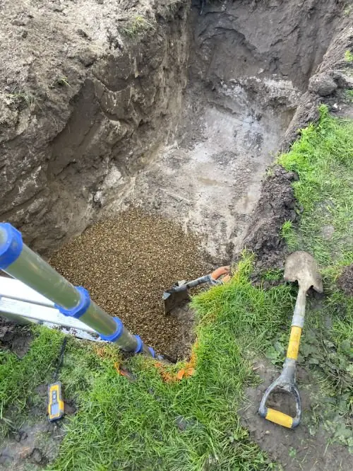 Mini digger carrying out an external drainage trench