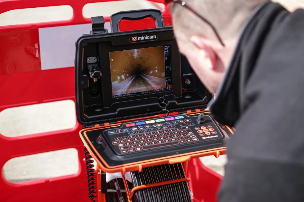 Minicam CCTV drain survey monitor showing live pipe footage